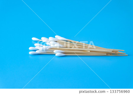 A swab clean health care top view,cotton bud on blue background. A swab clean health care top view,cotton bud on blue background. 133756960