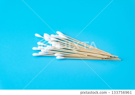 A swab clean health care top view,cotton bud on blue background. A swab clean health care top view,cotton bud on blue background. 133756961