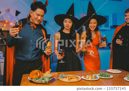 Joyful office Halloween party with coworkers in costumes, celebrating with drinks and laughter, fostering teamwork and festive spirit 133757145