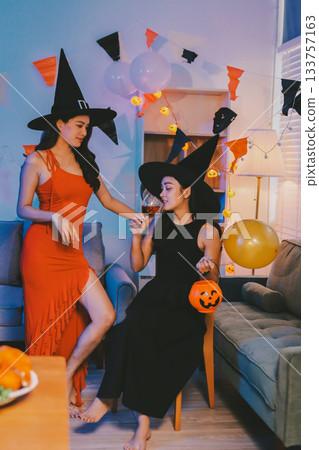 Joyful office Halloween party with coworkers in costumes, celebrating with drinks and laughter, fostering teamwork and festive spirit 133757163