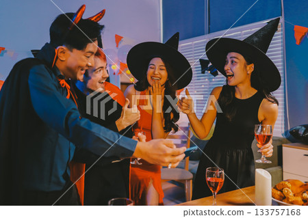 Joyful office Halloween party with coworkers in costumes, celebrating with drinks and laughter, fostering teamwork and festive spirit 133757168