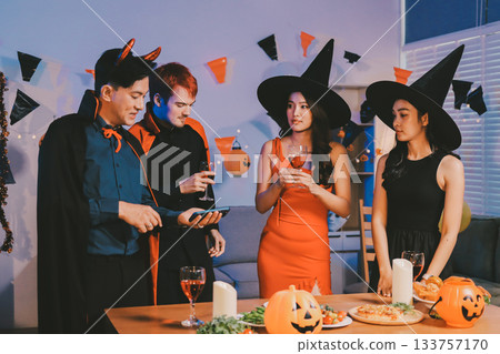 Joyful office Halloween party with coworkers in costumes, celebrating with drinks and laughter, fostering teamwork and festive spirit Joyful office Halloween party with coworkers in costumes, celebrating with drinks and laughter, fostering teamwork and festive spirit 133757170