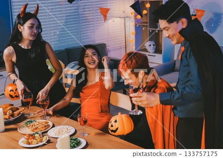 Joyful office Halloween party with coworkers in costumes, celebrating with drinks and laughter, fostering teamwork and festive spirit Joyful office Halloween party with coworkers in costumes, celebrating with drinks and laughter, fostering teamwork and festive spirit 133757175