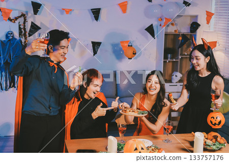 Joyful office Halloween party with coworkers in costumes, celebrating with drinks and laughter, fostering teamwork and festive spirit Joyful office Halloween party with coworkers in costumes, celebrating with drinks and laughter, fostering teamwork and festive spirit 133757176