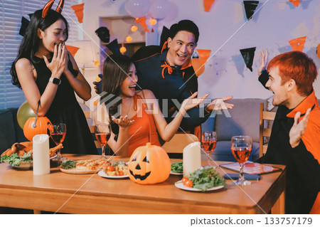 Joyful office Halloween party with coworkers in costumes, celebrating with drinks and laughter, fostering teamwork and festive spirit 133757179