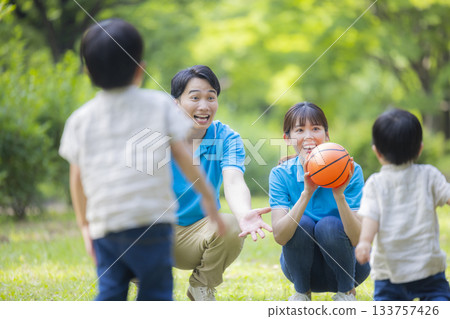 Male and female staff in blue polo shirts playing with children 133757426