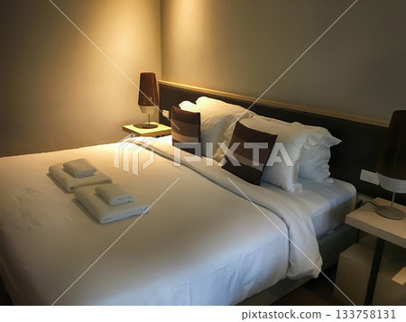 Cozy Hotel Bedroom Interior with Warm Lighting Cozy Hotel Bedroom Interior with Warm Lighting 133758131