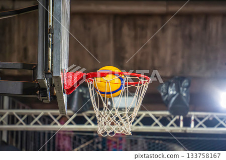 Basketball Mid-Air Above Hoop 133758167