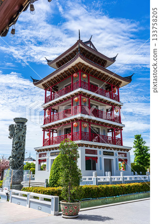 Tall Chinese-style pagoda tower against blue sky 133758205