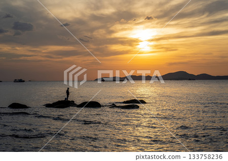Sunset Fishing Scene on Coastal Rocks Sunset Fishing Scene on Coastal Rocks 133758236