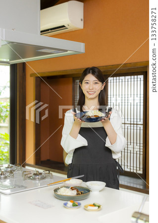 Woman preparing food in the kitchen Woman preparing food in the kitchen 133758271
