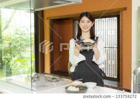 Woman preparing food in the kitchen 133758272