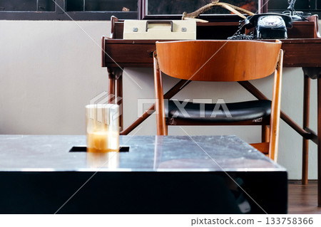 Detail image of a living room with wooden chair and table. 133758366