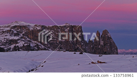 Panoramic view of Dolomite mountain peaks in beautiful morning light. Early winter scene with snow covered summits. Panoramic view of Dolomite mountain peaks in beautiful morning light. Early winter scene with snow covered summits. 133758961