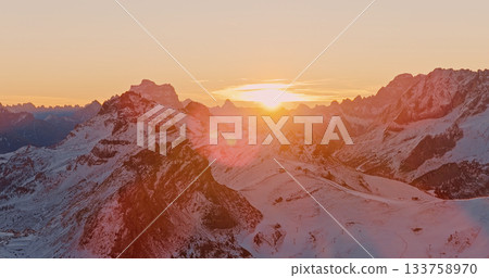 Panoramic view of Dolomite mountain peaks in beautiful morning light. Early winter scene with snow covered summits. Panoramic view of Dolomite mountain peaks in beautiful morning light. Early winter scene with snow covered summits. 133758970