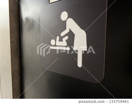 Sign on entrance door to nursery for diaper changes. Symbol of mother changing her baby diaper. Facilities in public place for parents with infants. Changing your baby diaper 133759461