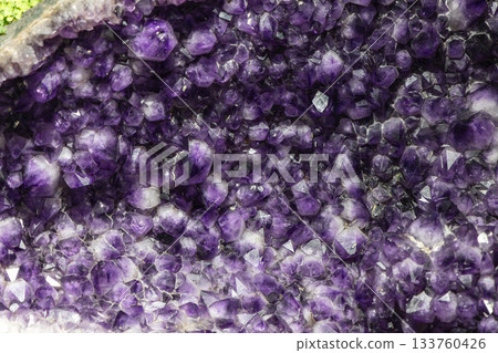 Amethyst crystal cluster in macro view with vivid purple quartz tips and glossy geometric texture 133760426