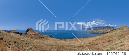 Panoramic view of Ponta de Sao Lourenco Madeira with dry hills blue sea and distant mountains 133760458