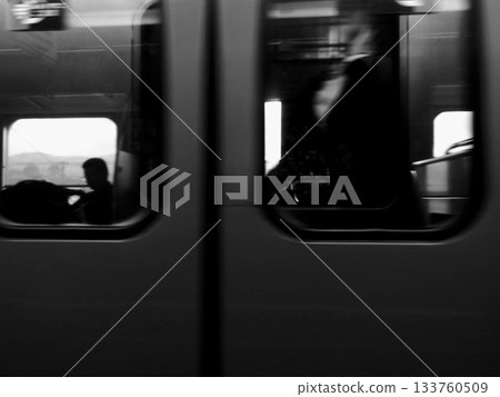 Passengers and blurred scenery through a train window Passengers and blurred scenery through a train window 133760509