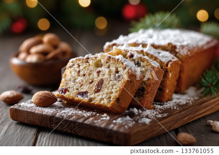 Delicious fruitcake topped with powdered sugar and nuts served on a wooden board Delicious fruitcake topped with powdered sugar and nuts served on a wooden board 133761055