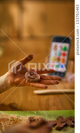 Child showing clay smiley figure in hand 133761465