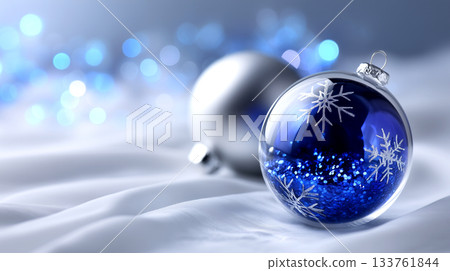 Sparkling blue and silver Christmas ornaments shimmer on soft white fabric with a bokeh background, evoking festive cheer and elegant holiday celebrations. Sparkling blue and silver Christmas ornaments shimmer on soft white fabric with a bokeh background, evoking festive cheer and elegant holiday celebrations. 133761844