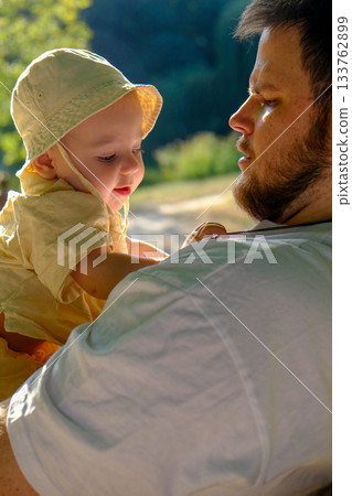 Father and Baby Relaxing in Sunny Park 133762899