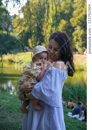 Joyful Mother and Baby by the Lake 133762904