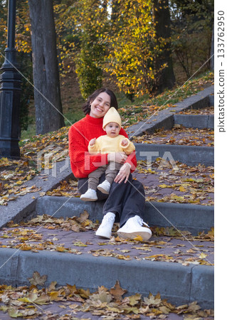 Mother and baby enjoying autumn outdoors Mother and baby enjoying autumn outdoors 133762950