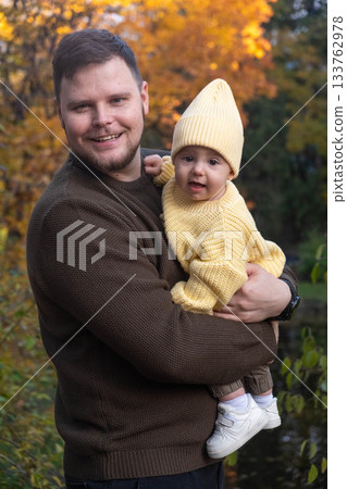 Father and Baby Enjoying Autumn Sunlight 133762978