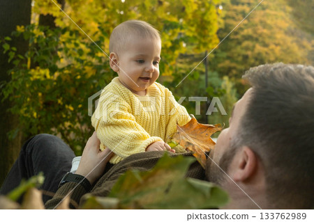 Father and Baby Enjoying Autumn Leaves 133762989