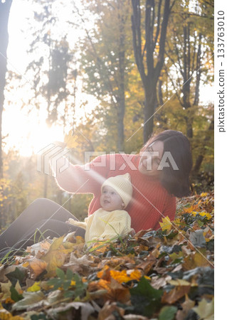Mother and Baby Enjoying Autumn in Sunlit Forest Mother and Baby Enjoying Autumn in Sunlit Forest 133763010