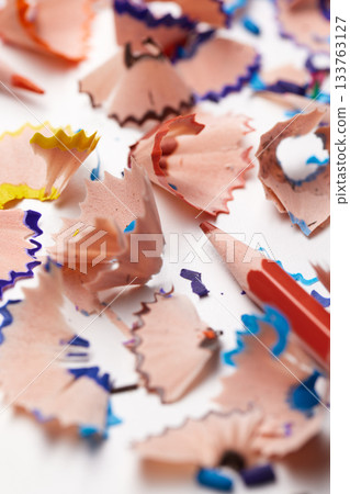 Colorful pencil shavings with drawing pencils and a sharpener on a white background 133763127