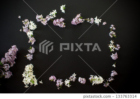 Floral frame of white and purple lilac on black background 133763314