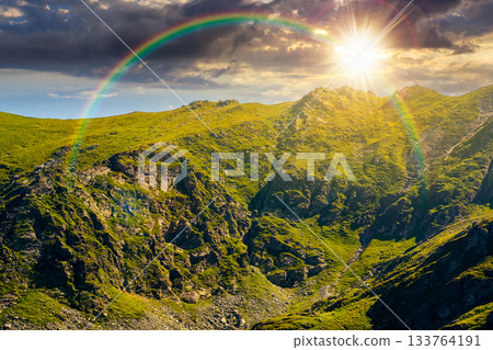 mountain landscape in summer at sunset. ridge under blue sky with clouds in evening light. alpine scenery with rocky peaks and steep slopes. storytelling image of place for hiking under the rainbow mountain landscape in summer at sunset. ridge under blue sky with clouds in evening light. alpine scenery with rocky peaks and steep slopes. storytelling image of place for hiking under the rainbow 133764191