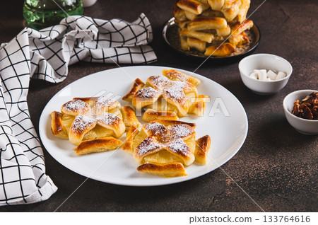 Mini baked pineapple tarts on a plate on the table Mini baked pineapple tarts on a plate on the table 133764616