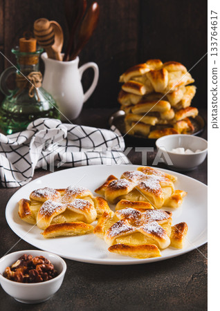 Sweet puff pastries with pineapple in powdered sugar on the table vertical view 133764617