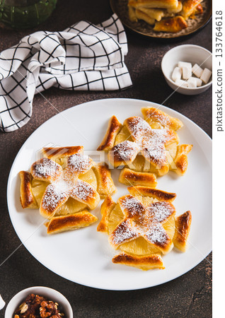 Mini baked pineapple tarts on a plate on the table vertical view 133764618