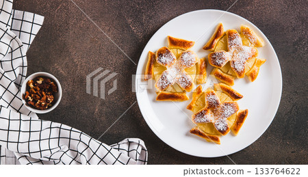 Mini baked pineapple tarts on a plate on the table top view web banner 133764622