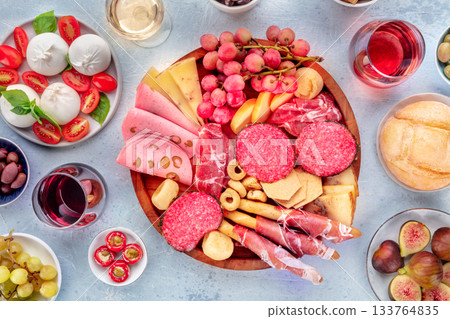 Italian Antipasti. Charcuterie tray with cheese and other appetizers, with wine Italian Antipasti. Charcuterie tray with cheese and other appetizers, with wine 133764835