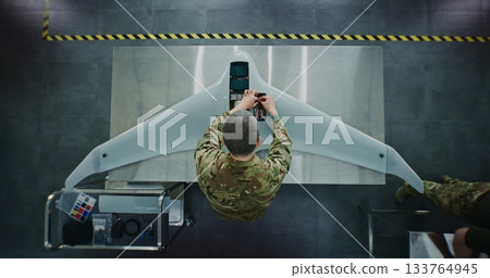 Engineer in Military Uniform Assembling Unmanned Aerial Vehicle Engineer in Military Uniform Assembling Unmanned Aerial Vehicle 133764945
