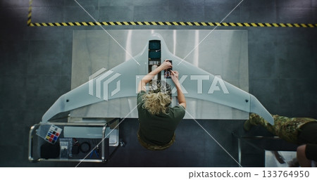 Woman in Camouflage Uniform Working on Next Generation Drone 133764950