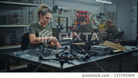 Military Grade Drone Assembly By Focused Female Defense Worker Military Grade Drone Assembly By Focused Female Defense Worker 133765004