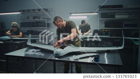 Synchronized Drone Production Team Simultaneously Assembling Large UAV Synchronized Drone Production Team Simultaneously Assembling Large UAV 133765023