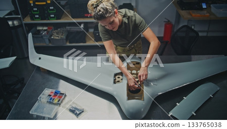 Organized Drone Factory Features Several Stations Where Engineers Assembling Large UAVs Organized Drone Factory Features Several Stations Where Engineers Assembling Large UAVs 133765038