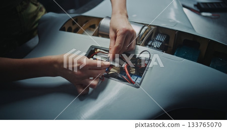 Worker Hand Assembling Critical Electronic Modules Into Next Generation Drone Worker Hand Assembling Critical Electronic Modules Into Next Generation Drone 133765070