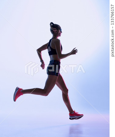 Futuristic female runner mid-stride in soft neon gradient background 133766157