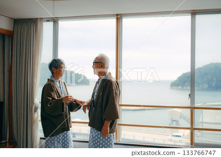 A gentle moment for a senior couple adjusting the collar of their yukata A gentle moment for a senior couple adjusting the collar of their yukata 133766747