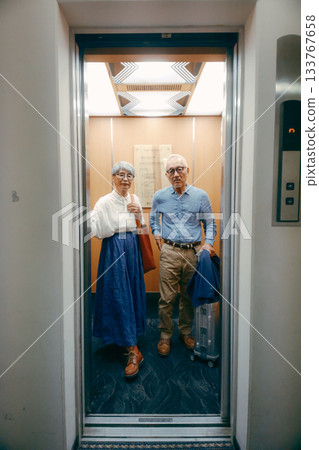 Travel scene of a senior couple riding an elevator Travel scene of a senior couple riding an elevator 133767658