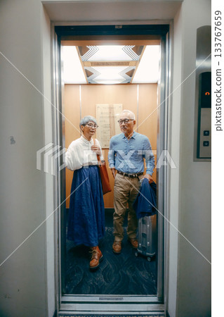 Travel scene of a senior couple riding an elevator Travel scene of a senior couple riding an elevator 133767659